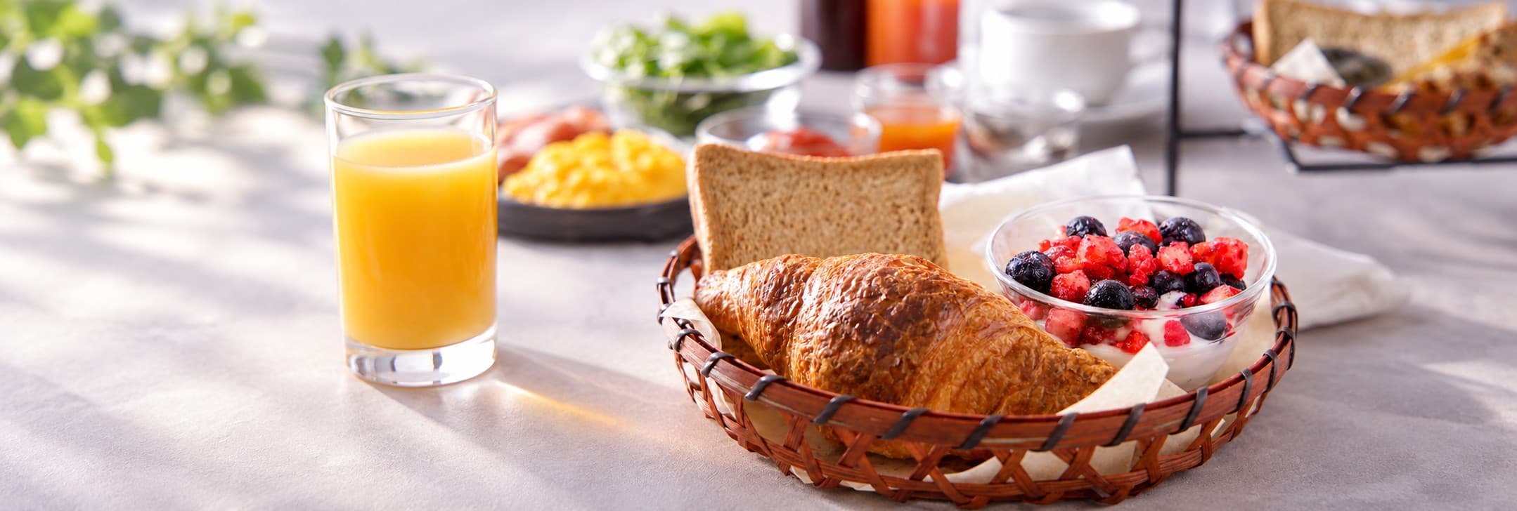 Continental breakfast with croissant, mixed berries and scrambled eggs